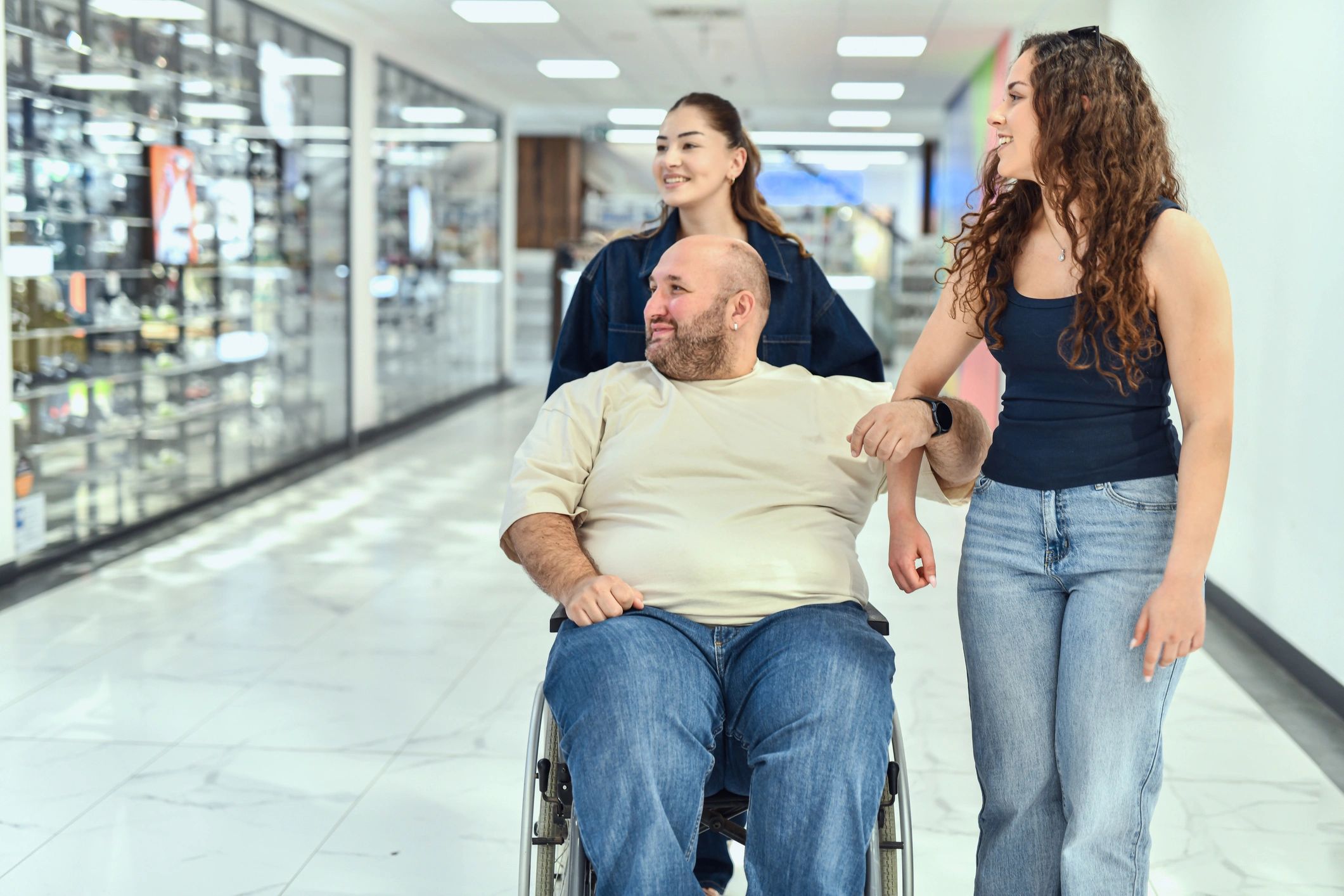 Supportive community outing with a person using a wheelchair and friends