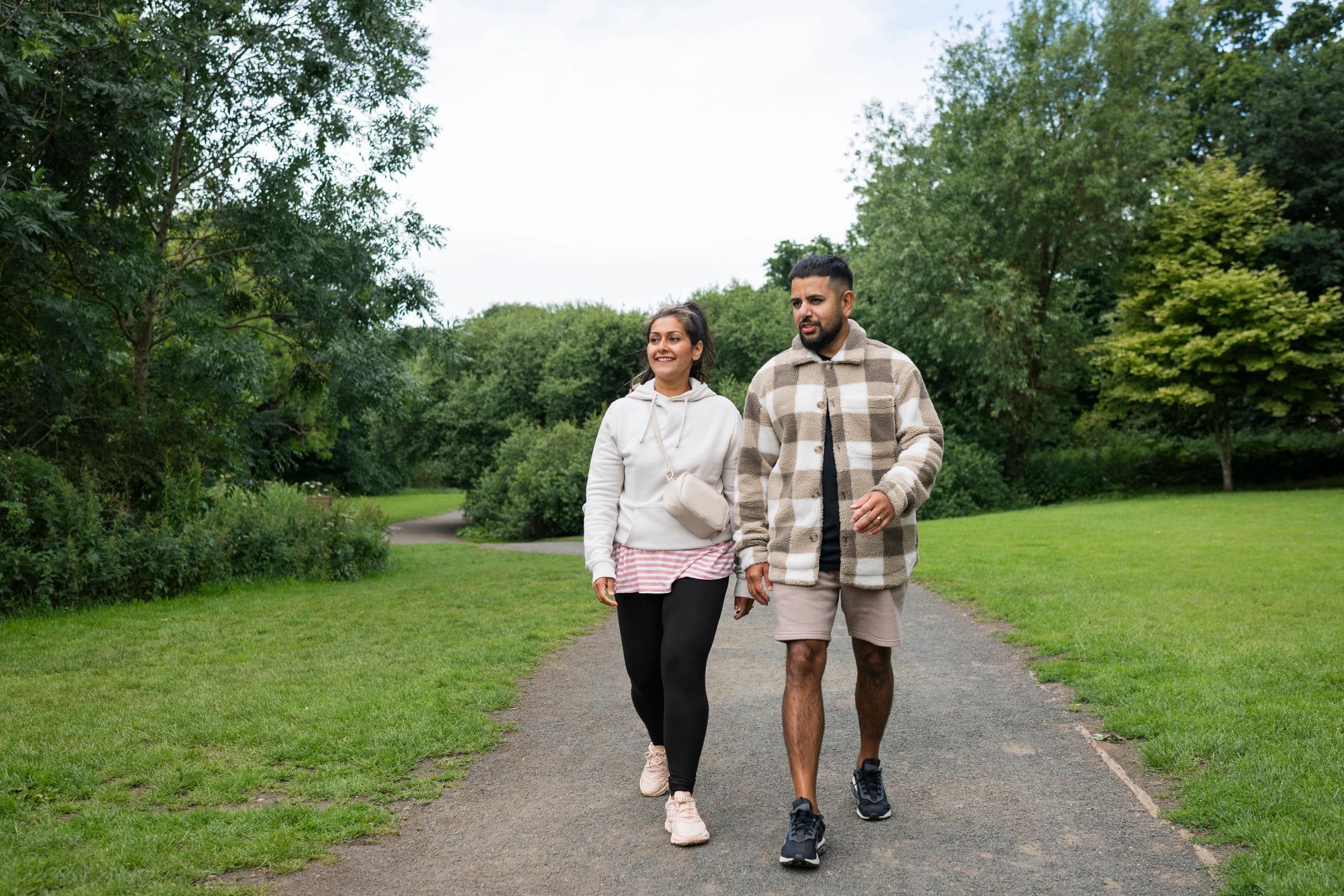 Two adults walking together in a public park